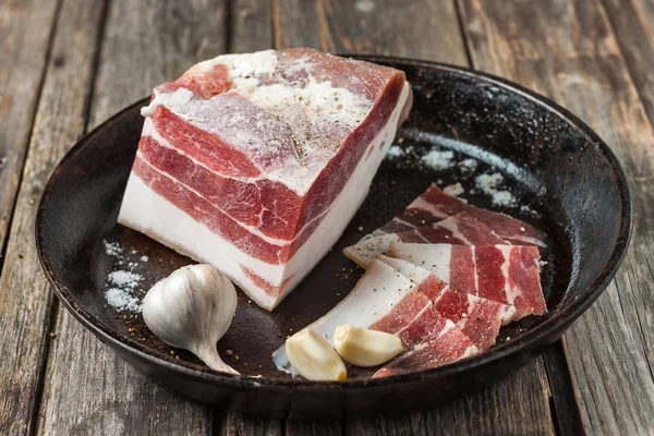 Salty bacon with garlic and black pepper. — Stock Image Salty bacon with garlic and black pepper. Royalty Free Stock Images