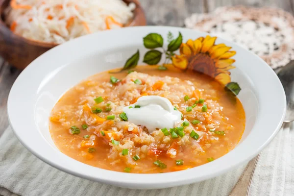Soup with sauerkraut and millet. Russian kitchen. rustic style — Stock Image Soup with sauerkraut and millet. Russian kitchen. rustic style Stock Image