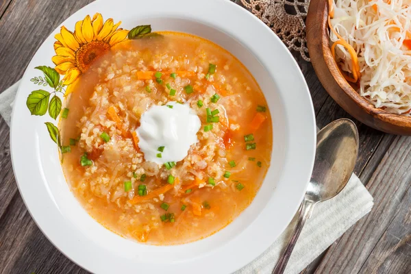 Soup with sauerkraut and millet. Russian kitchen. rustic style — Stock Image Soup with sauerkraut and millet. Russian kitchen. rustic style Royalty Free Stock Images