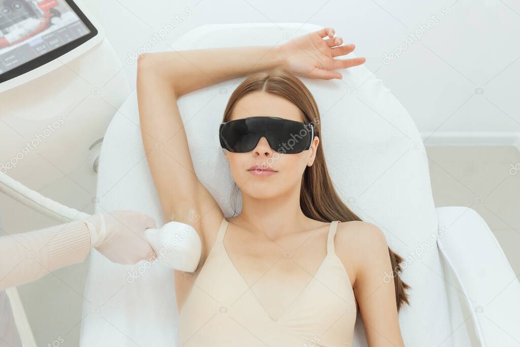 Woman has a laser epilation and cosmetology procedure