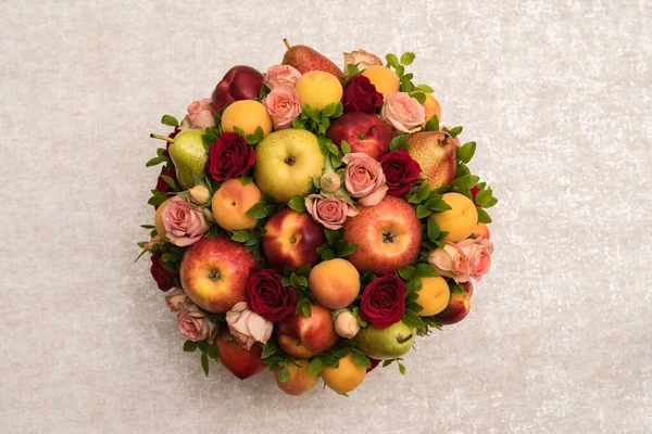 Gift floral fruit bouquet on light background close up
