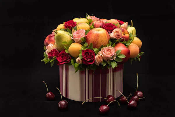 Gift floral fruit bouquet on dark background close up