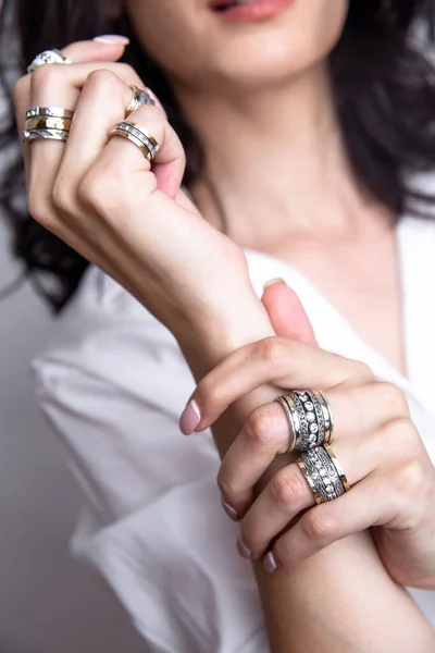 Female hands with jewelry near the face — Stock Photo, Image