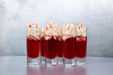 set of red cocktails with cream on a gray background.