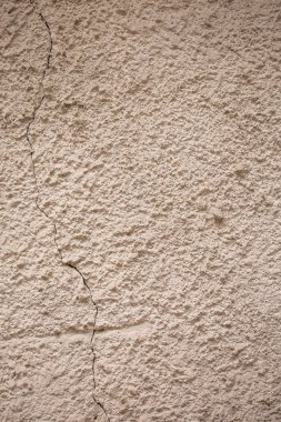Beton ve kumdan yapılmış bej desenli duvar. Tasarım için doğal arkaplan.