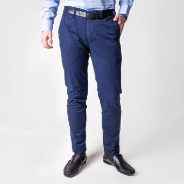 guy in dark blue pants against the wall.