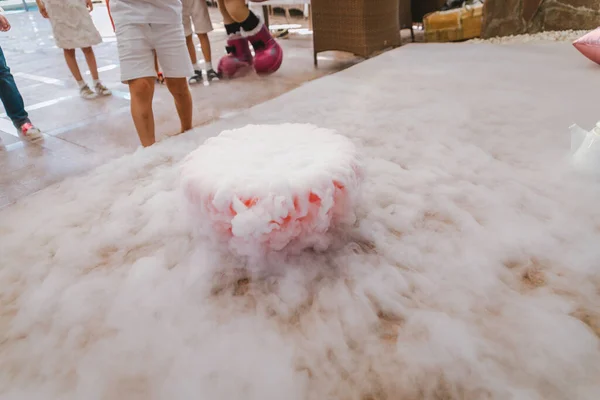 dry ice in a bowl on the floor. fog from dry ice on holiday.