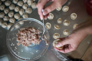 cooking homemade dumplings close - up view from above.