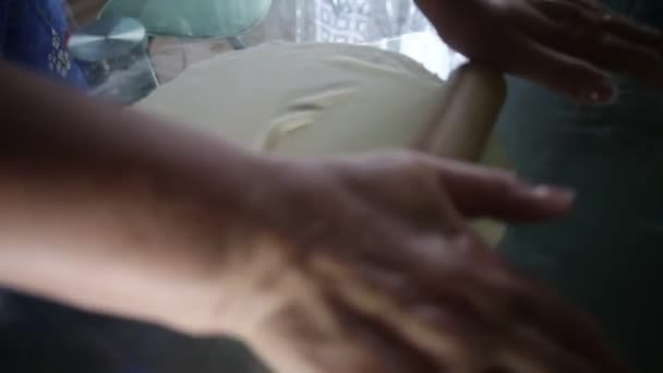 Une femme roule la pâte sur la table pour les boulettes — Video