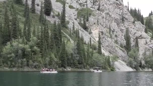 Una barca e un catamarano navigano su un lago di montagna — Video Stock