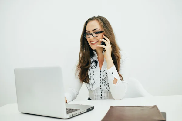 Pretty business woman with notebook in the office and writing dates on notebook — Stock Photo, Image
