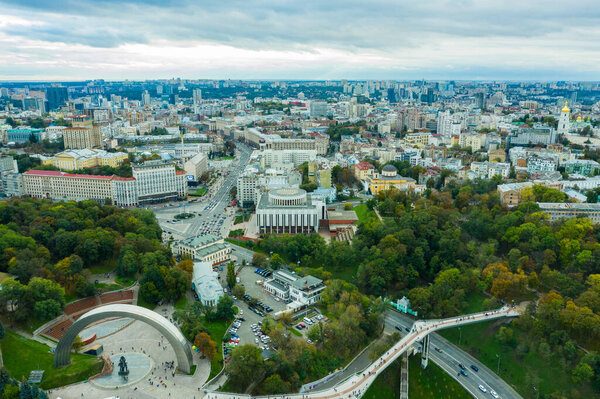 Aerial view of new pedestrian cycling park bridge construction, hills, parks and Kyiv cityscape from above, city of Kiev skyline, Ukraine