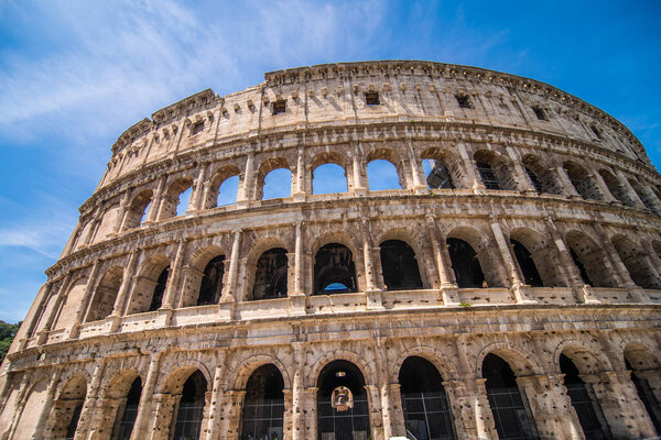 Rome, Italy - Juny, 2021: Ancient Roman Coliseum or Colosseum is one of the main travel destinations in Europe. Tourists visit the Coliseum in summer. Beautiful view of the famous Coliseum ruins.