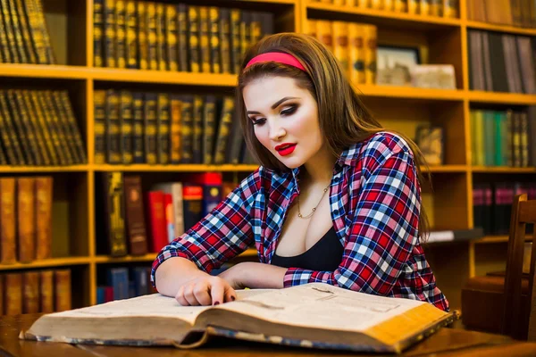 Clever female student hair ponytail girl  sitting  in  library with  books. Indoor