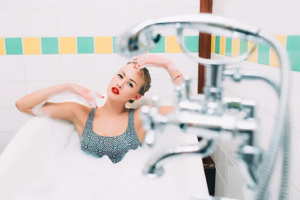 Passionate young caucasian lying in white bathroom — Zdjęcie stockowe