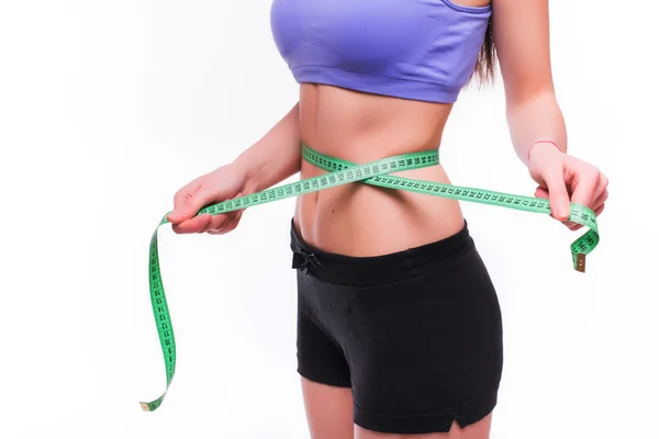 Fit and healthy young lady measuring her waist — Stock Photo, Image