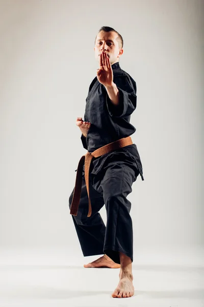 Young male with orange belt karate fighter training. — Stock Photo, Image