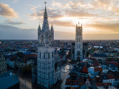 Drone footage highlighting Ghent historic skyline with ancient towers and narrow streets.