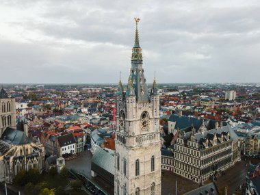 High aerial view showing Ghents traditional rooftops and church towers.