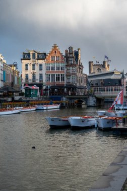 Ghent, Belgium - October 5, 2025 - Elegant canal promenade in Ghents historical district with old houses and bridges.