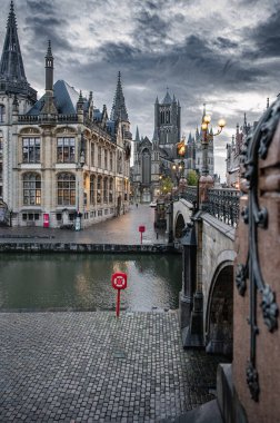 Ghent, Belgium - October 5, 2025 - Peaceful scene of a pedestrian walkway beside Ghents canal and heritage houses.