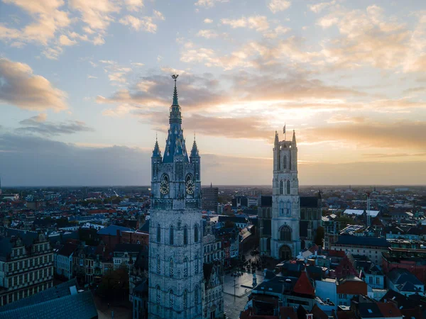 Drone view capturing Ghents skyline with medieval towers and colorful rooftops.