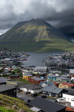 Faroe Adaları, Danimarka, Kuzey Atlantik 'teki fiyort ve dağların arasına yerleşmiş Klaksvik şehrinin nefes kesici panoramik manzarası..