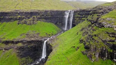 Muhteşem Fossa şelalesi, Faroe Adaları 'nın en yüksek şelalesi, Kuzey Atlantik' in engebeli kayalıklarından aşağı dökülüyor..