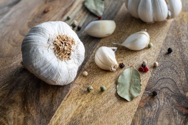 Köy ahşap kesim tahtasının üzerinde çiğ sarımsak sergileniyor..