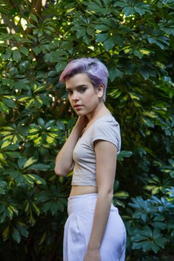 Açık havada kameraya bakarak Menekşe kısa saçlı kadın