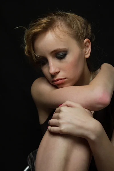 Sad blonde looking aside, , black background — Stock Photo, Image