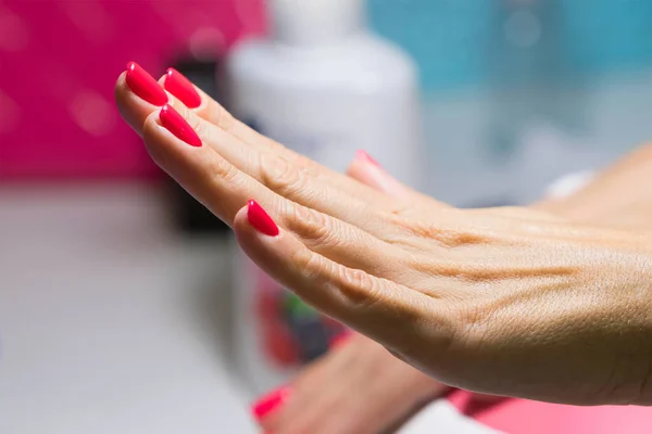 Groomed female hand on a manicure lamp