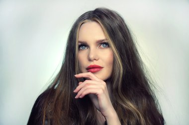 Woman model posing at studio in the light flashes.