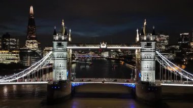London. UK- October 07. 2025. A rising close up aerial clip of Tower Bridge to reveal a beautiful city skyline at night.
