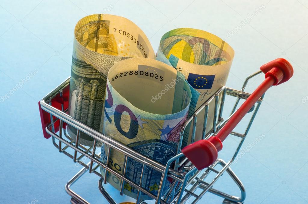 A shopping cart with euro coins, symbolic photo for purchasing
