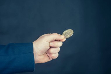 Sanal para birimi ve engelleme zinciri kavramı. Elinde Bitcoin tutan mavi ceketli bir iş adamı.