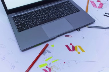 Bir Grafik Tasarımcısının yaratıcı işyeri. Şirket için bir logo geliştirme. Bir sanat stüdyosundaki çizimler ve eskizler.