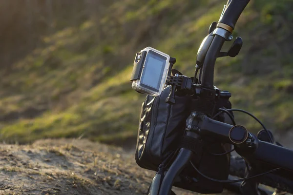Action Camera on a bike with a bikepacking bag in a waterproof case against the backdrop of nature