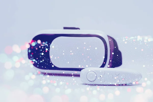 Remote control in the background of glasses for virtual reality and 360-degree video on a technological bright and colored background with blur