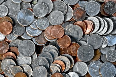 Coins laying in a pile clipart