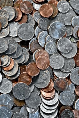 Coins laying in a pile clipart