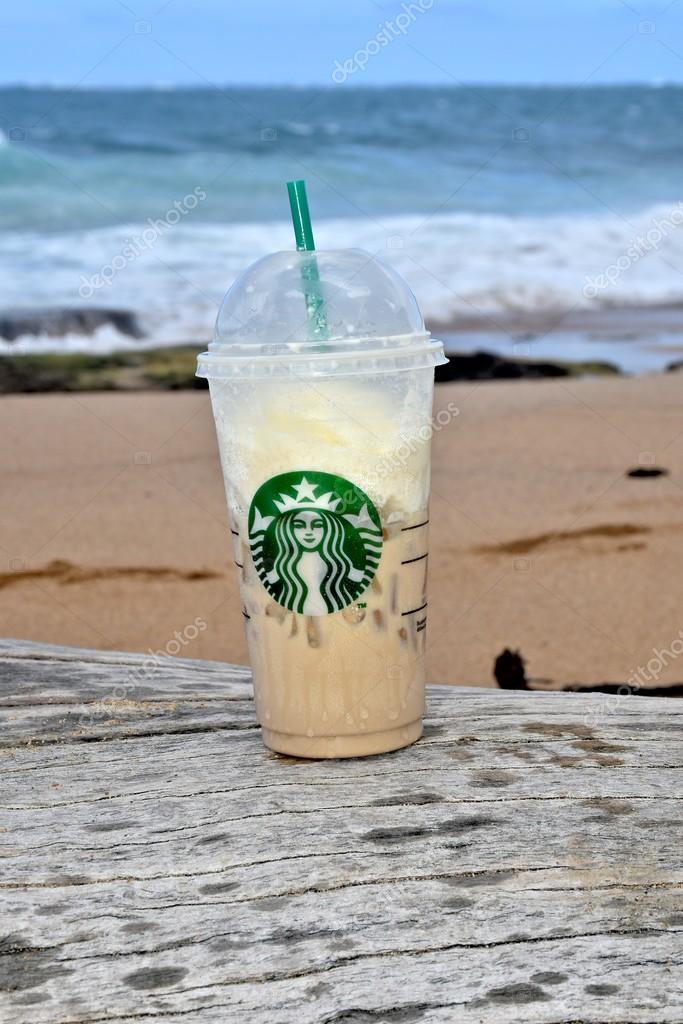 CONDADO, PUERTO RICO - JANUARY 25, 2016: A Starbucks coffee on the beach. Starbucks Corporation is an American coffee company and coffeehouse chain.