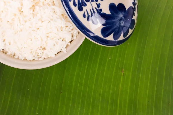 Rice in cup on green banana leaf — Stock Photo, Image