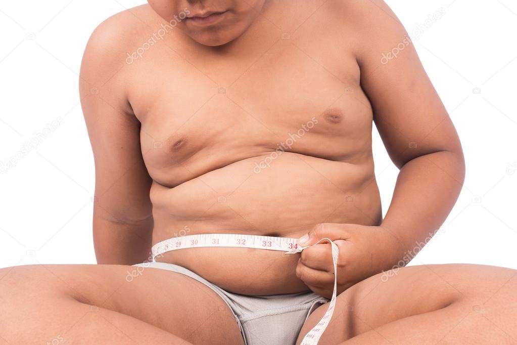 Cute boy measuring belly fat 
