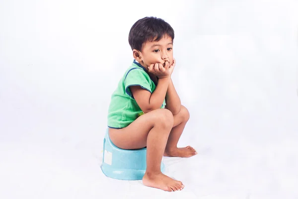 Little asian boy defecate on white background — Stock Photo, Image