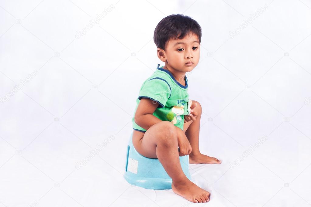 little asian boy defecate on white background