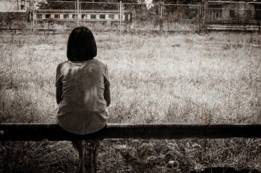 sad asian girl sitting alone  near railway Stations clipart