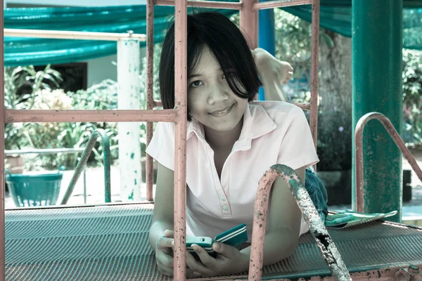 Cute asian girl play phone at playground — Stock Photo, Image