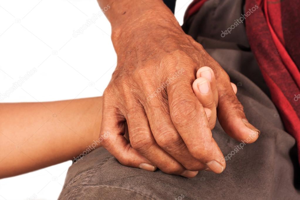 asian kids little boy hand touches and holds an old man wrinkled