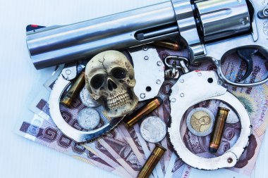 skull human with handcuff and revolver,bullet .375 on money bac clipart